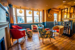 a restaurant with chairs and tables in a room at The Crown Hotel in Glastonbury