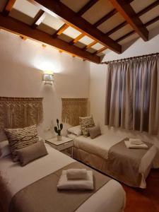 a bedroom with two beds and a window at Villas El Pinar in Cala en Blanes +52 photos