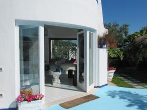 an open door of a white house with flowers at Relais Bijoux Ischia in Ischia