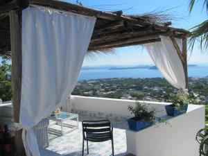 a balcony overlooking a beach with a view of the ocean at Relais Bijoux Ischia in Ischia