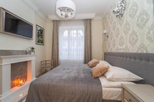A bed or beds in a room at Victus Apartamenty, Apartament Cassino Residence