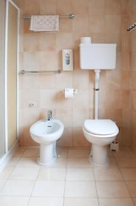 a bathroom with a toilet and a sink at Hotel Lory - Molveno - Dolomiti in Molveno