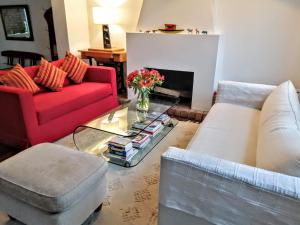 una sala de estar con 2 sofás y un jarrón de flores en Rooms in House on the Boardwalk of Barranco, en Lima