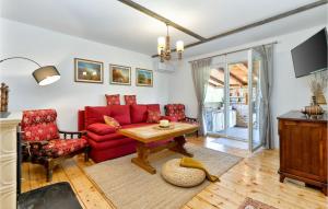 a living room with a red couch and a table at Gorgeous Home In Prugovac With House A Panoramic View in Prugovac