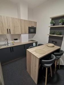 a kitchen with a table and chairs and a sink at Sareza hotel in Ostrava