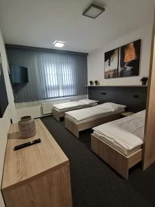a room with three beds in a room at Sareza hotel in Ostrava