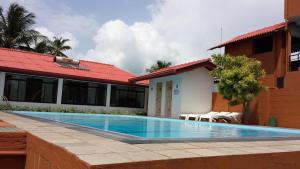 a swimming pool in front of a building at Ranga Holiday Resort in Bentota