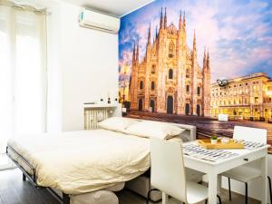 a bedroom with a bed and a cathedral mural at Casa Vacanze Macchi in Milan