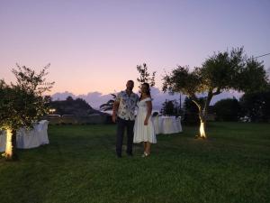 a man and a woman standing in a field at Aloni Studios and Apartments in Lassi