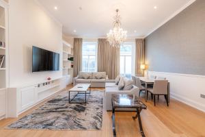 a living room with a couch and a tv at 20 Hertford Street in London