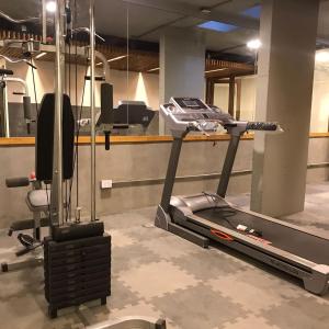 a gym with a treadmill and a chair in a room at ALIWENSMA Rauli in San Martín de los Andes