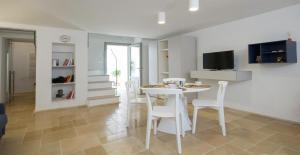 a kitchen and living room with a table and chairs at Santa Marina Bed&Breakfast in Massafra