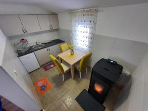 a small kitchen with a table and a stove at DION Kolašin in Kolašin