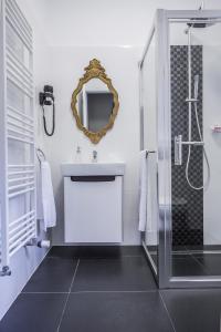 a bathroom with a shower and a sink and a mirror at Casa Timpuri Vechi in Sibiu