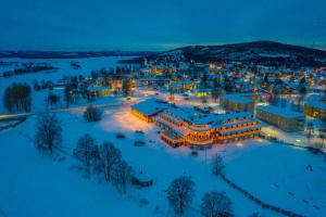 ÖverkalixにあるGrand Arctic Resortの夜の雪の中のリゾートの空中ビュー