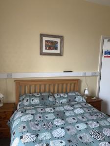 A bed or beds in a room at Brafferton Guest House