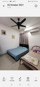 a bedroom with a bed and a ceiling fan at Majestic Ipoh in Ipoh