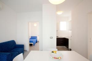 Appartamenti Emma في كاورلي: غرفة معيشة مع طاولة وكرسي أزرق