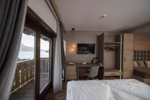 a hotel room with a bed and a window at Ariston Lake View Hotel in Molveno