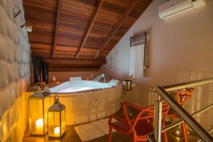 a large room with a large bed and a large window at Modevie Boutique Hotel in Gramado