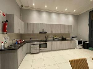 a large kitchen with wooden cabinets and appliances at Ikhaya in Cape Town