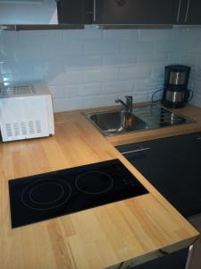 a kitchen with a counter with a sink and a stove at Magicappart in Magny-le-Hongre