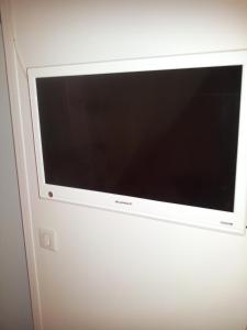 a flat screen television hanging on a wall at Magicappart in Magny-le-Hongre