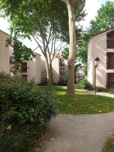 a park with trees and a street light next to a building at Magicappart in Magny-le-Hongre