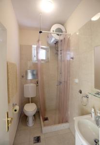 a bathroom with a shower and a toilet and a sink at Studio Stari Grad in Herceg-Novi