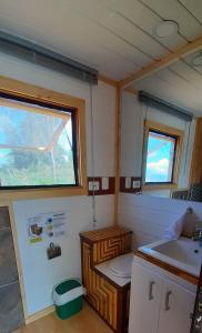 a small bathroom with a sink and a window at Mini Casa Barichara in Barichara