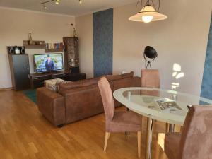 a living room with a couch and a table at Benkelberg in Sitzerath