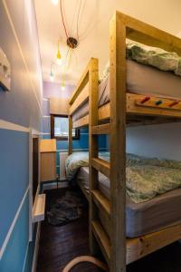 a room with three bunk beds in a house at The Woodland Lodge - Wood Fired Hot Tub and Firepit in Hambleton
