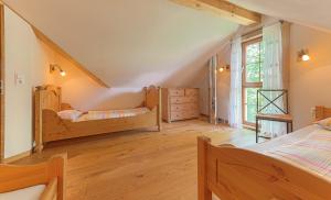 a bedroom with two beds and a window at Ferienhof Harr in Freudenstadt