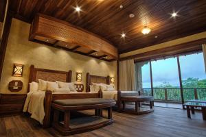 a bedroom with a large bed and a balcony at The Springs Resort & Spa at Arenal in Fortuna