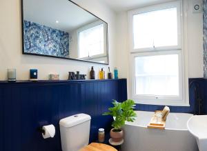 a bathroom with a tub and a sink and a mirror at Host & Stay - Marine Sands in Scarborough