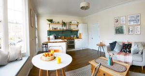 a living room with a table and a kitchen at Host & Stay - Marine Sands in Scarborough