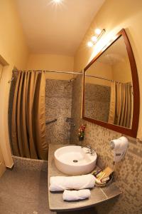 a bathroom with a sink and a mirror at Hotel Arequipa Vive in Arequipa