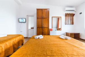 two beds in a room with two towels on them at Casa Luca 2 in Vama Veche