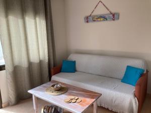 a living room with a couch and a table at Casa Camar in Corralejo +13 photos