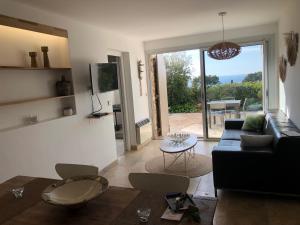 a living room with a couch and a table at Calanque in Cassis