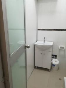 een badkamer met een wastafel en een glazen douchedeur bij Studio entero cerca al Palacio Gobierno in Lima