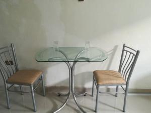 a glass table with two chairs sitting next to it at Studio entero cerca al Palacio Gobierno in Lima