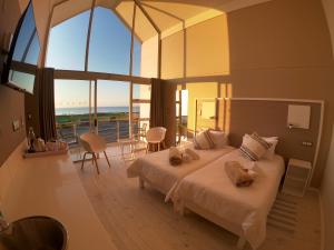 a bedroom with a large bed and a large window at AT THE SEA Boutique Guesthouse in Swakopmund +57 photos