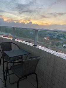 a table and two chairs on a balcony with a view at Apartamento 2 quartos West Flat in Mossoró