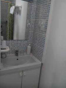 a bathroom with a sink and a mirror at Hôtel Lamartine in Dijon