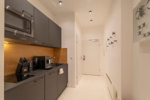 a kitchen with gray cabinets and a microwave at Albrecht I levestate in Vienna