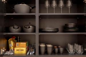 a pantry with pots and pans and dishes on shelves at Albrecht I levestate in Vienna