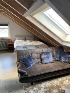 a couch with two pillows on it in a attic at Ferienwohnung Mayer in Langenargen
