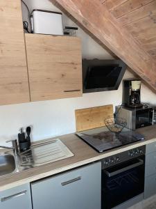 a kitchen with a sink and a stove top oven at Ferienwohnung Mayer in Langenargen