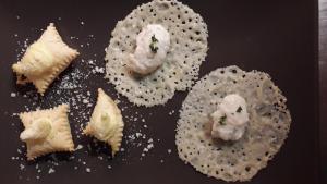a bunch of food on a black plate at LA TANA DEL PICCHIO in Neviano degli Arduini +39 photos